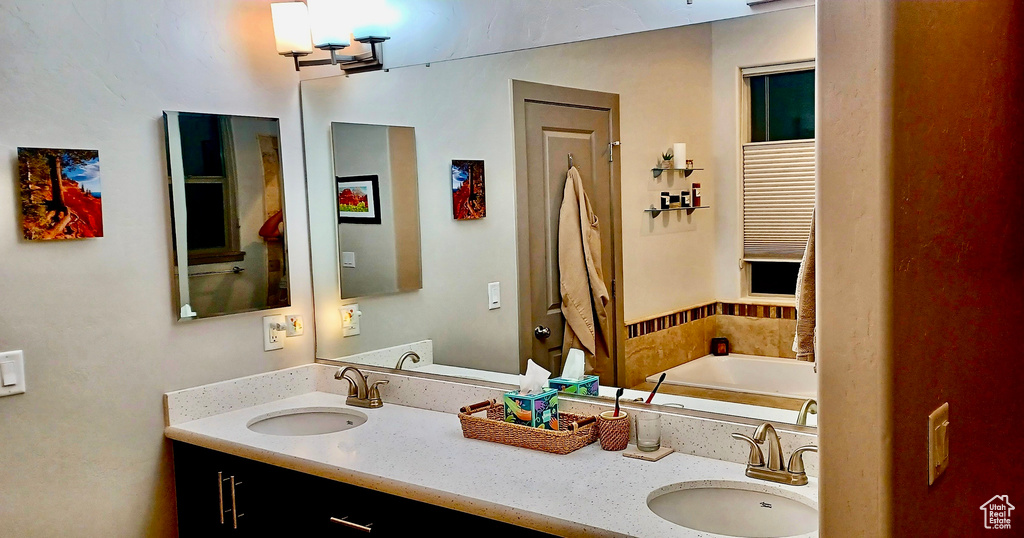 Full bathroom featuring double vanity and a garden tub