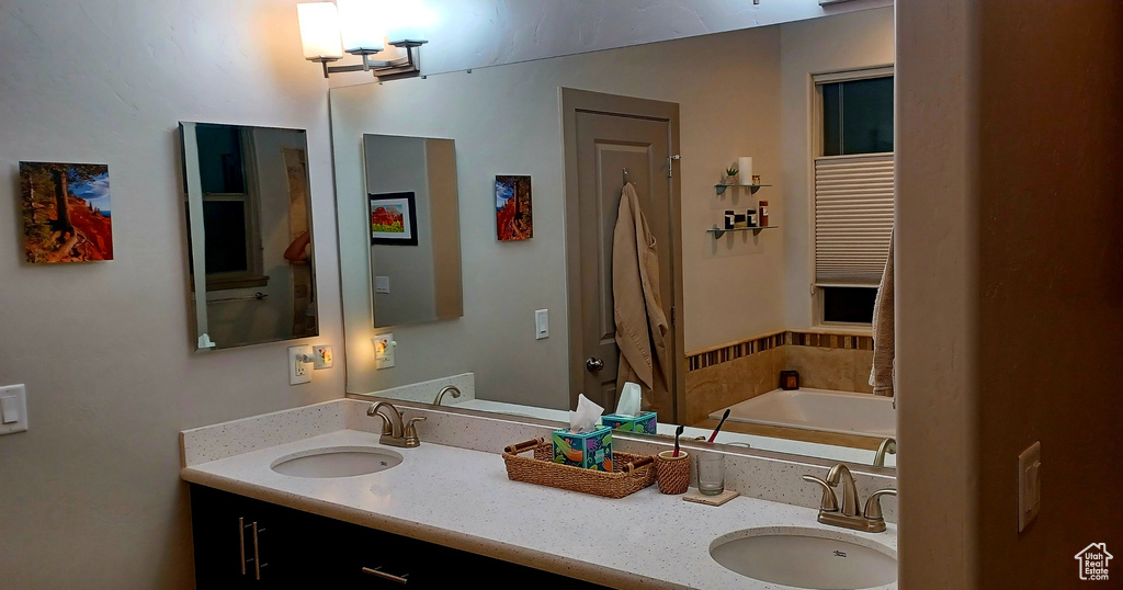 Bathroom with double vanity and a bath