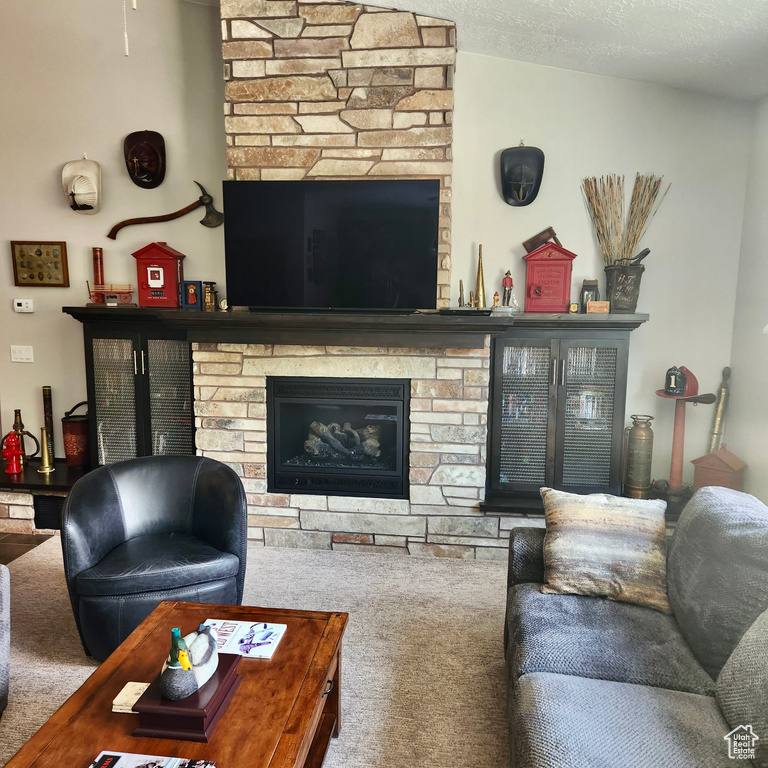 Living room with a fireplace and carpet