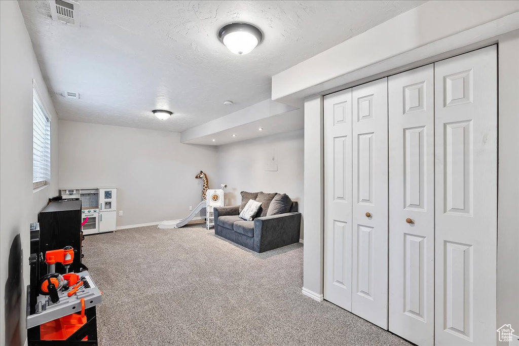 Rec room featuring carpet flooring and baseboards