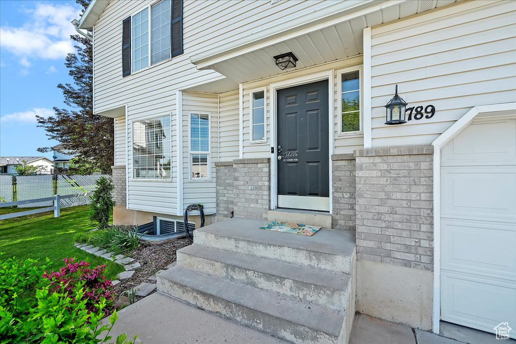 View of exterior entry featuring a garage
