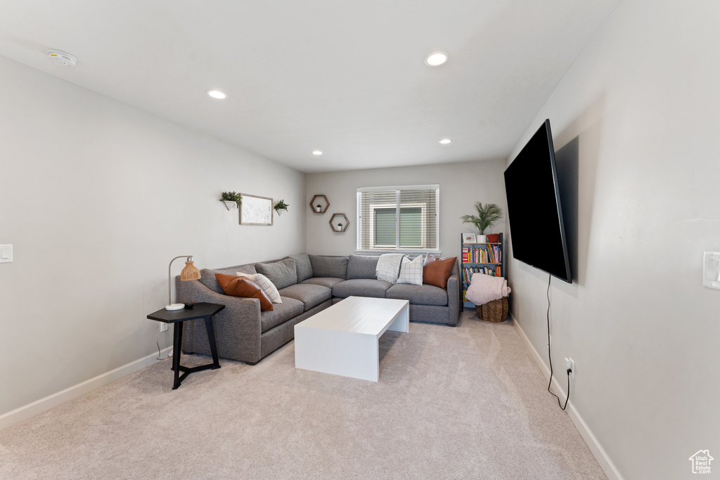 Living room featuring light carpet, recessed lighting, and baseboards