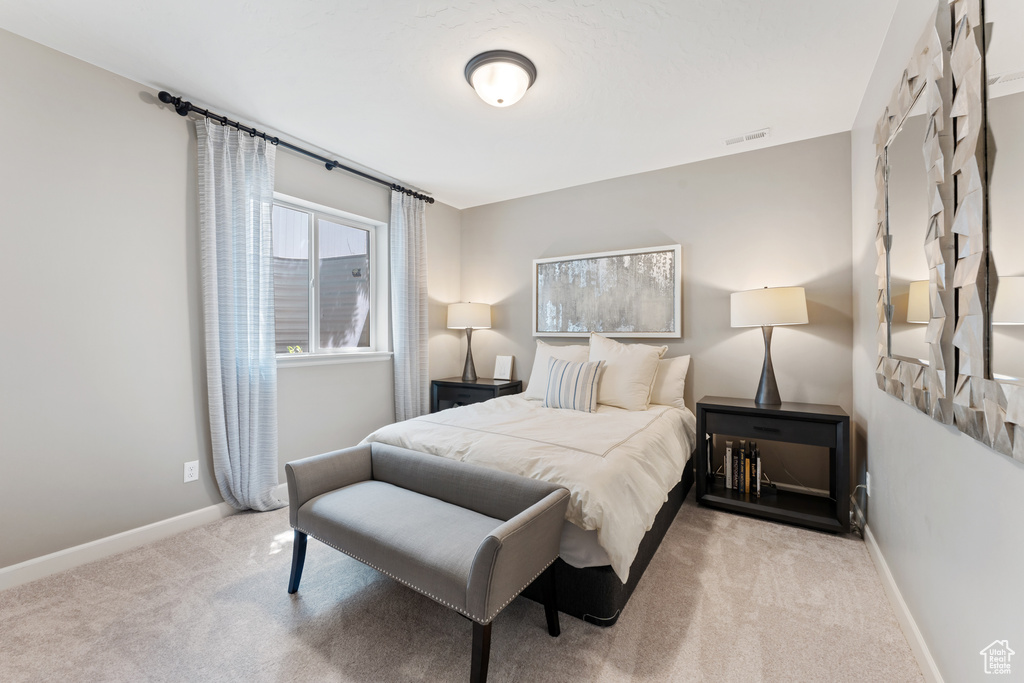 Carpeted bedroom featuring baseboards
