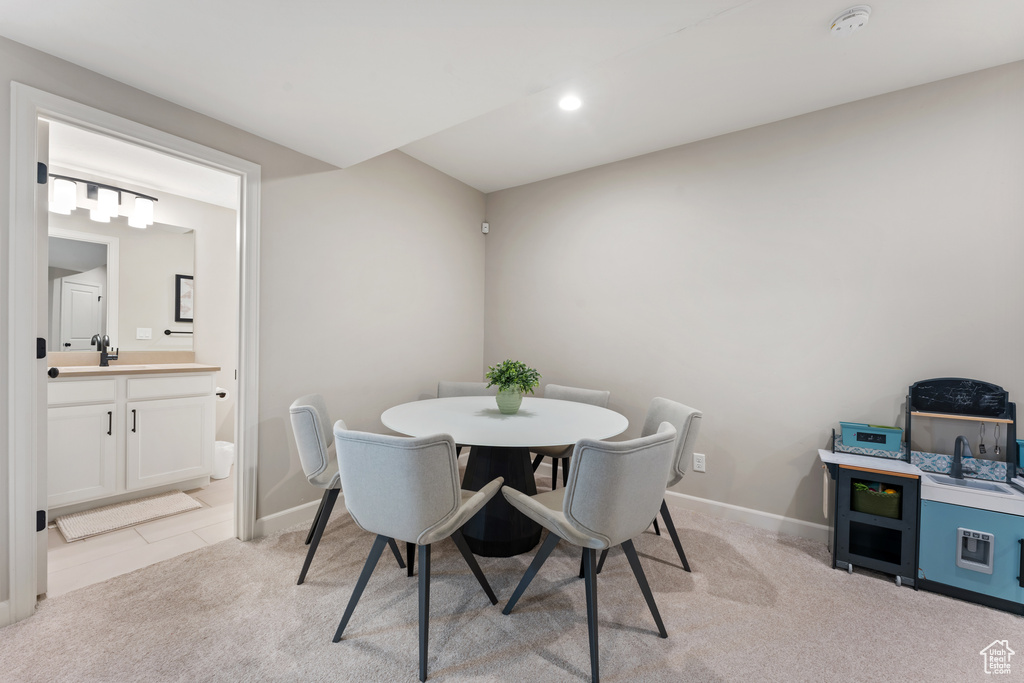 Dining space with baseboards, recessed lighting, and light colored carpet