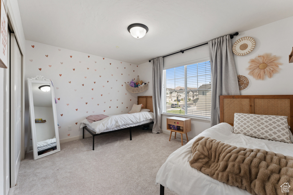 Carpeted bedroom with wallpapered walls and baseboards