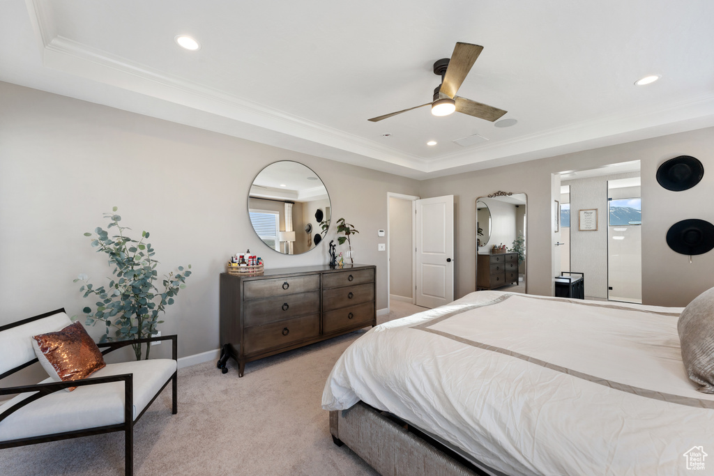 Bedroom with a raised ceiling, recessed lighting, light carpet, baseboards, and a ceiling fan
