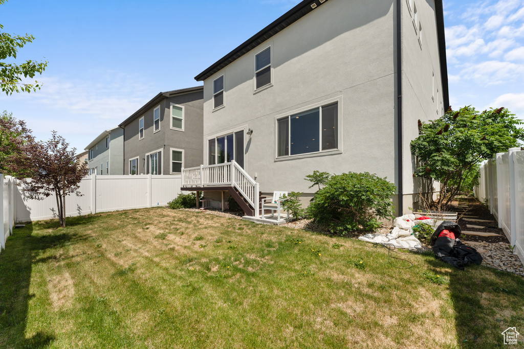 Back of house featuring stucco siding
