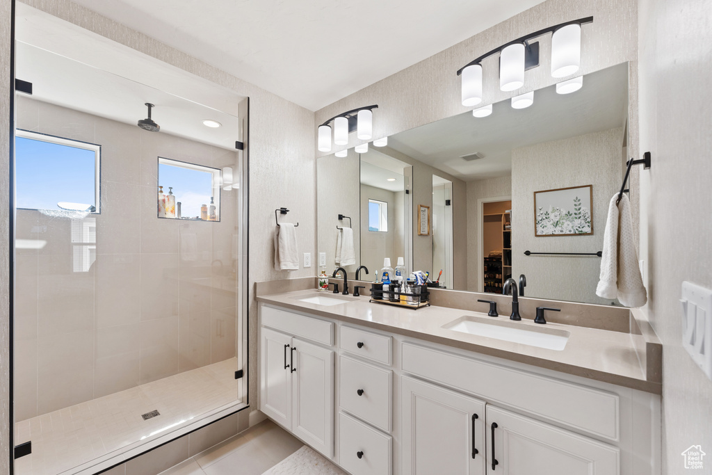 Bathroom with double vanity and a shower stall