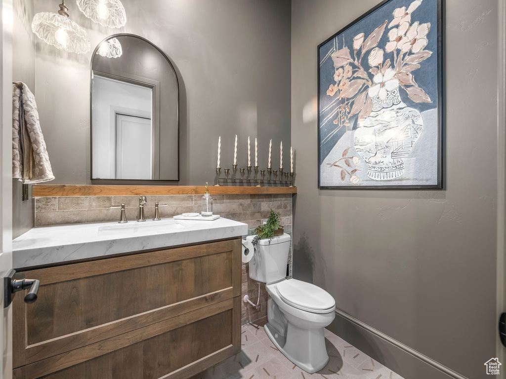 Bathroom with vanity, toilet, and tile patterned flooring