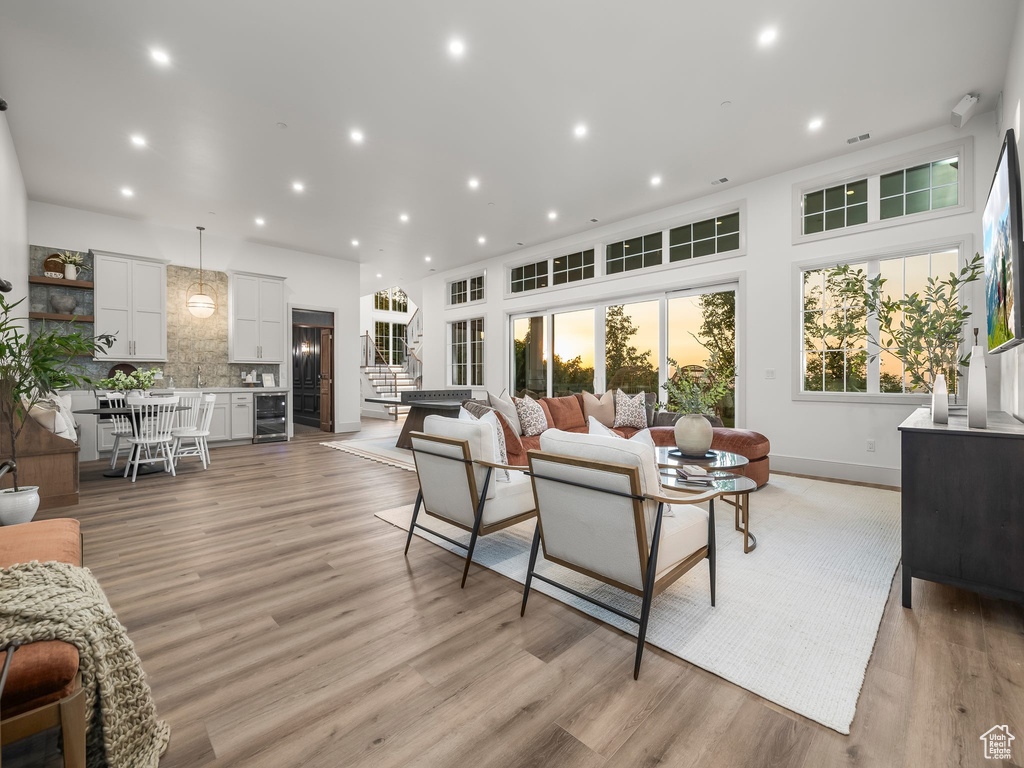 Living area featuring beverage cooler, light wood-style flooring, recessed lighting, and baseboards