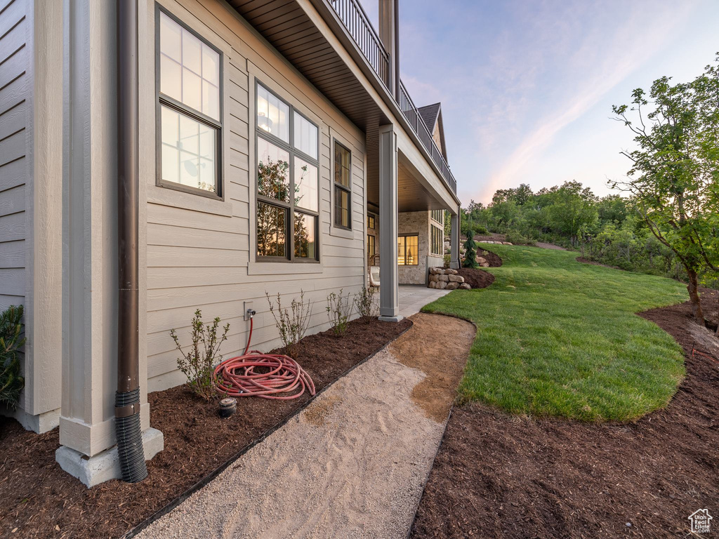 View of side of property with a lawn