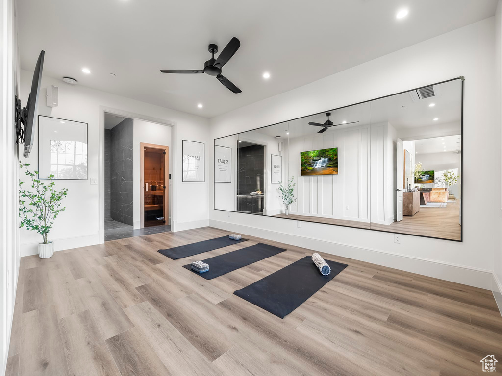 Workout area featuring ceiling fan, baseboards, wood finished floors, and recessed lighting