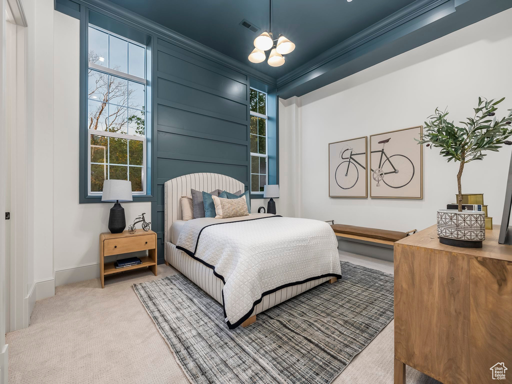 Bedroom featuring ornamental molding, carpet, baseboards, and a chandelier