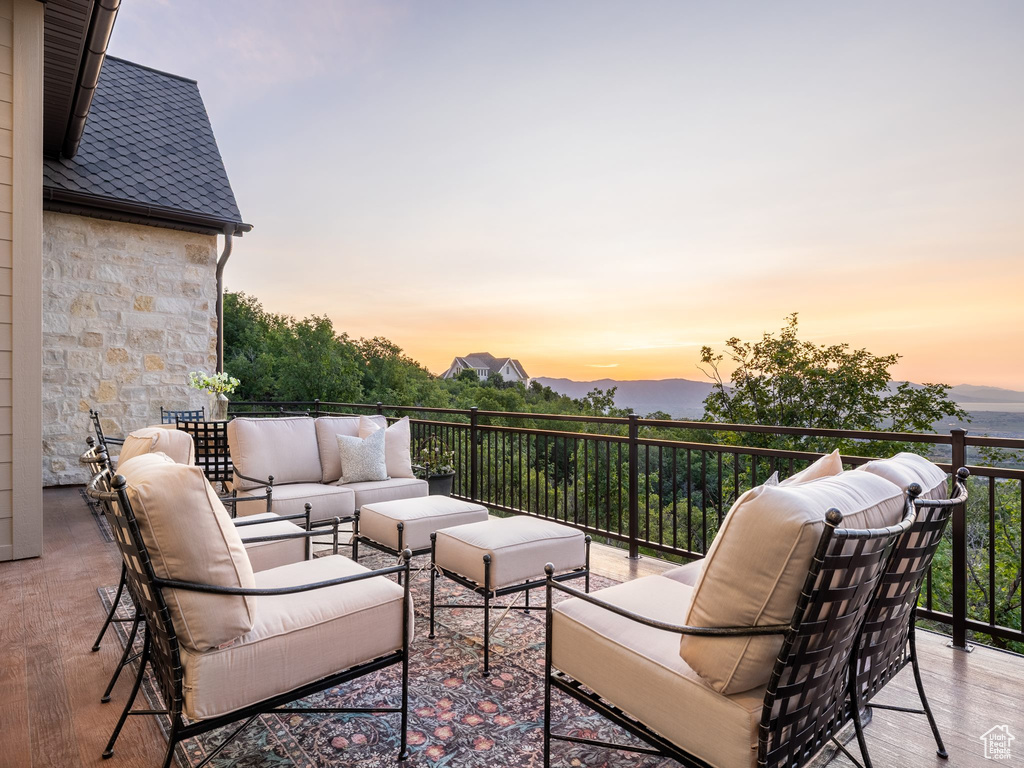 Patio terrace at dusk featuring an outdoor living space