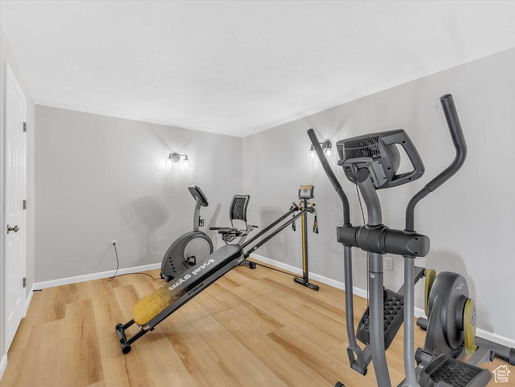 Workout area featuring wood finished floors and baseboards