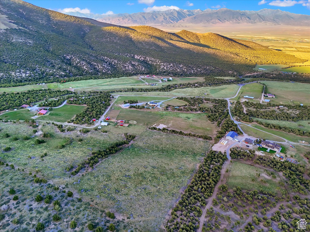 Aerial view of property and surrounding area with a mountain backdrop and rural landscape