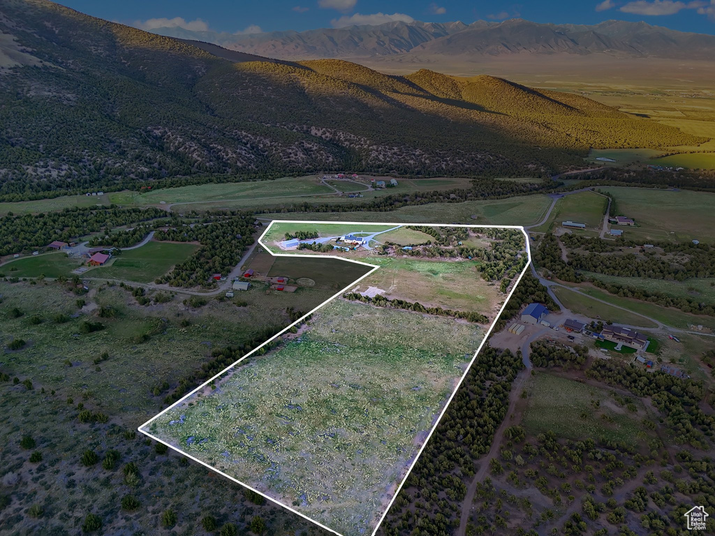 View of property location with property boundaries highlighted, a mountainous background, and rural landscape