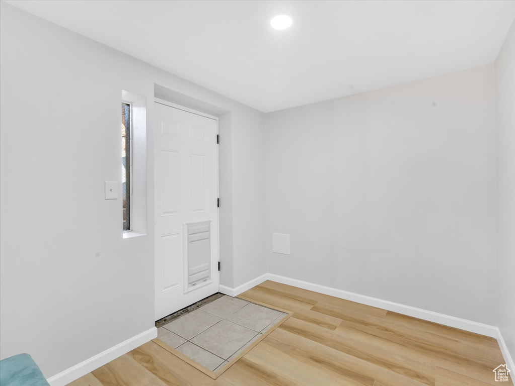 Unfurnished room with light wood finished floors and baseboards