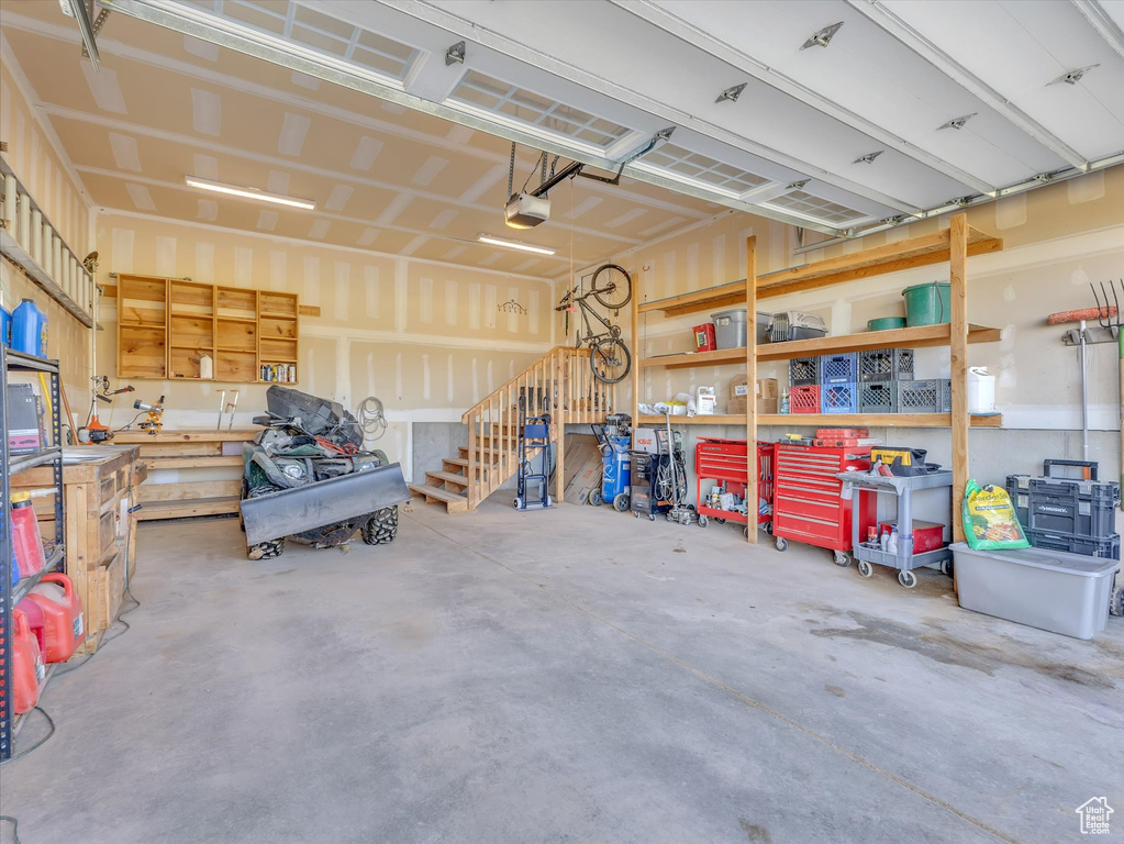 Garage featuring a workshop area and a garage door opener