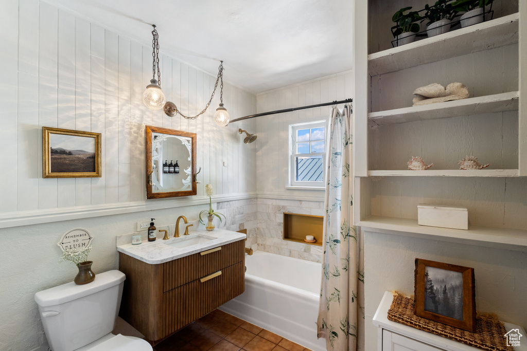 Bathroom with shower / tub combo, toilet, vanity, and tile patterned floors
