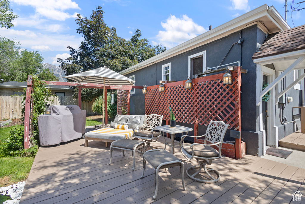 Wooden deck featuring outdoor lounge area