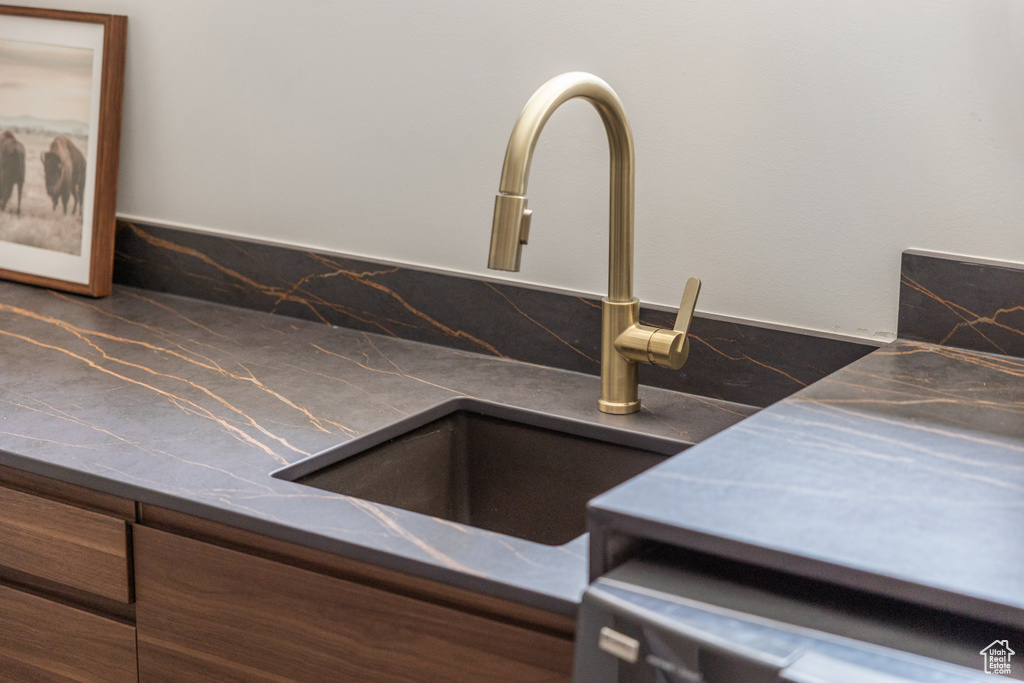 Kitchen view of a sink and stainless steel countertops