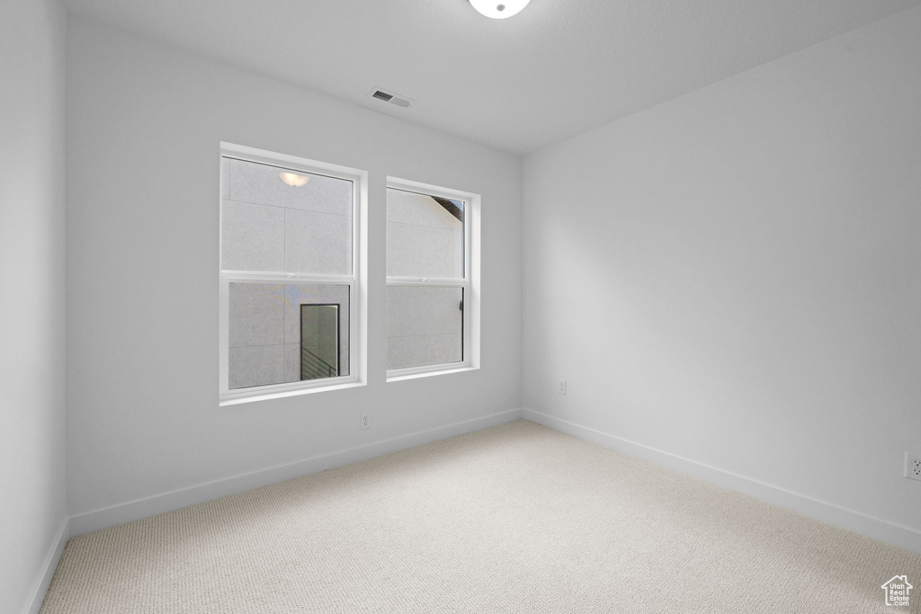 Carpeted empty room with baseboards