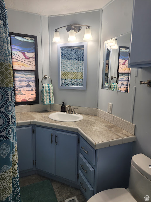 Full bathroom with vanity and toilet