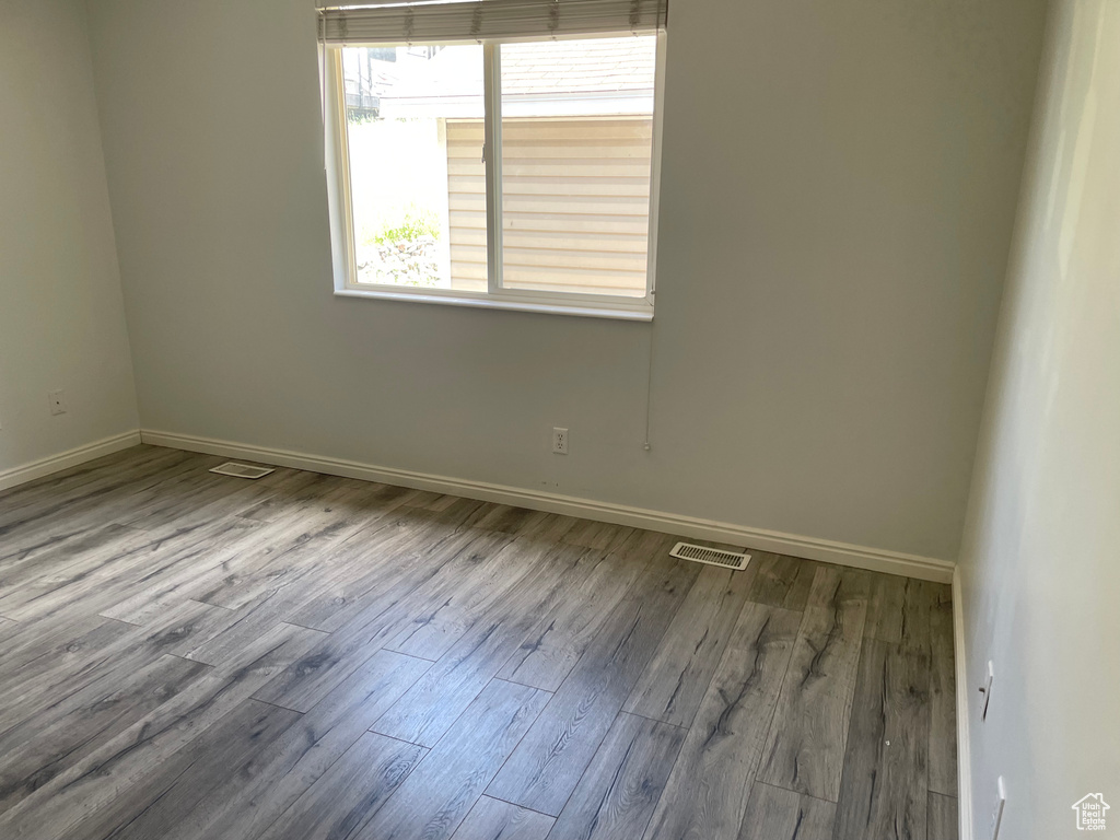 Empty room with baseboards and wood finished floors