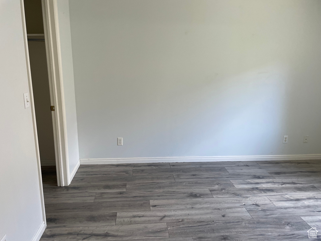 Unfurnished room featuring wood finished floors and baseboards