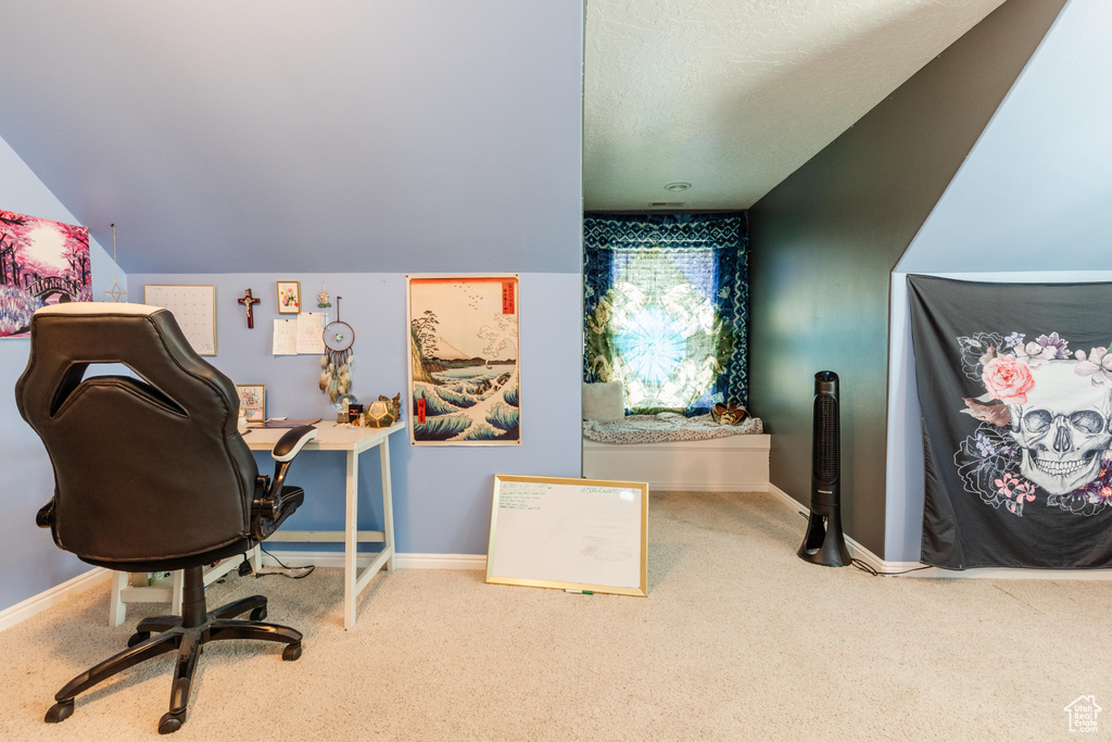 Carpeted office space with baseboards and a textured ceiling