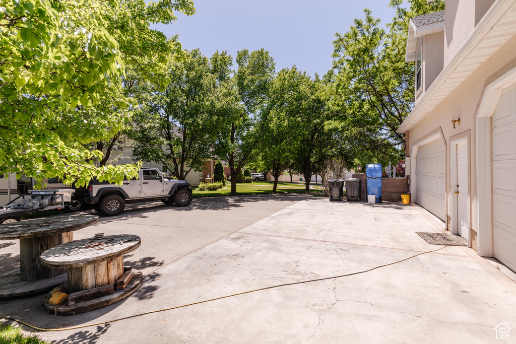 View of patio with driveway and a garage