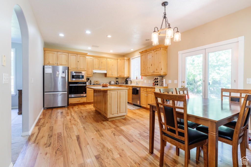Kitchen with stainless steel appliances, light brown cabinetry, light countertops, plenty of natural light, and recessed lighting