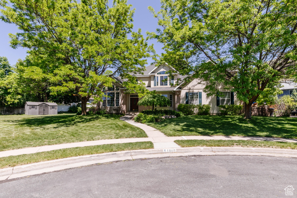 Obstructed view of property featuring a front lawn