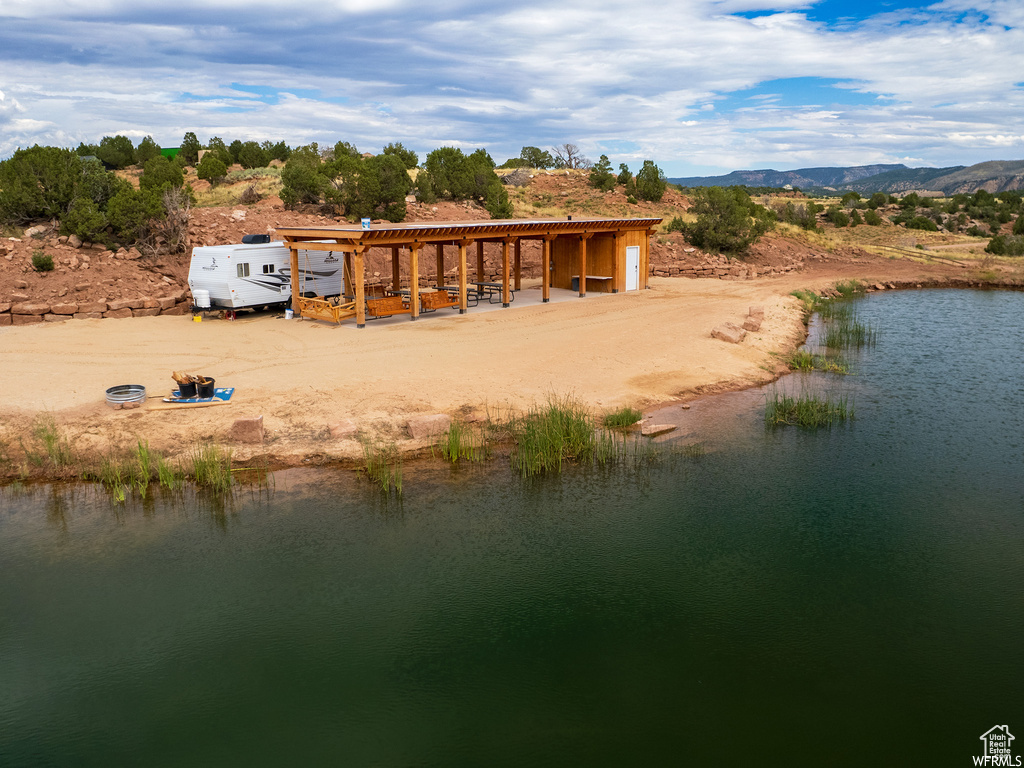Back of property with a water and mountain view