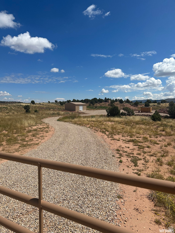 View of dirt / gravel driveway featuring a view of countryside