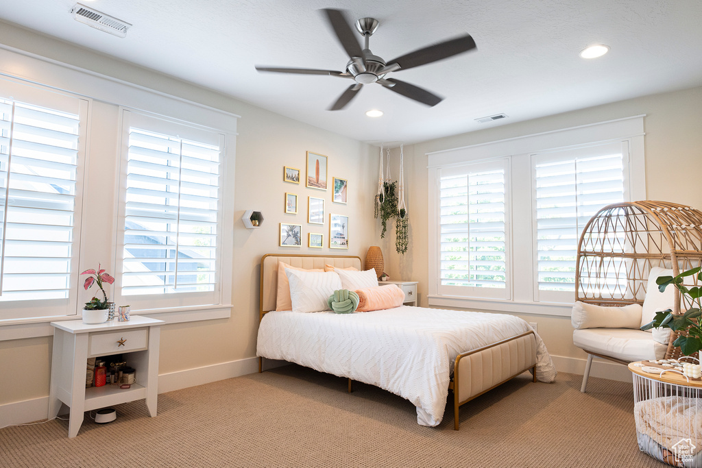 Bedroom featuring light carpet, baseboards, recessed lighting, and a ceiling fan