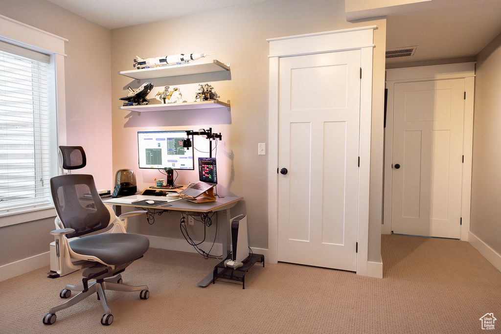 Carpeted office featuring baseboards