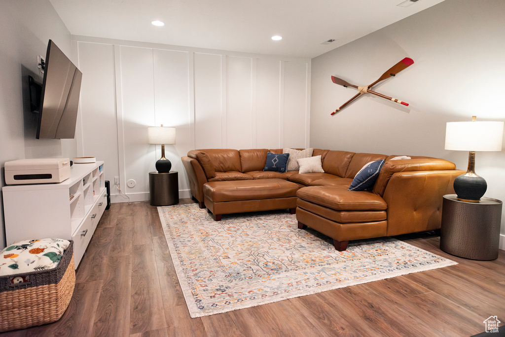 Living area with wood finished floors and recessed lighting