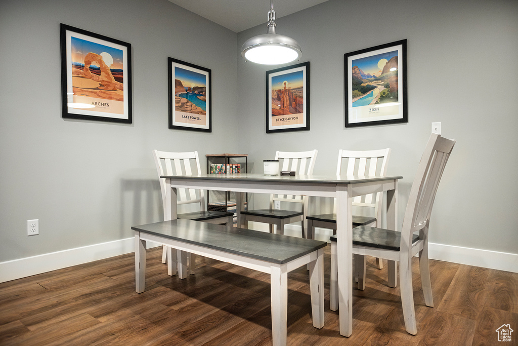 Dining space with baseboards and wood finished floors