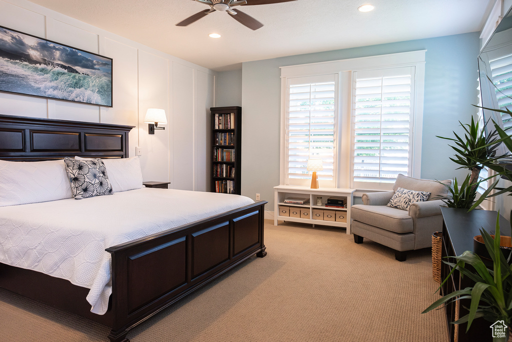 Bedroom featuring multiple windows, recessed lighting, light colored carpet, and ceiling fan