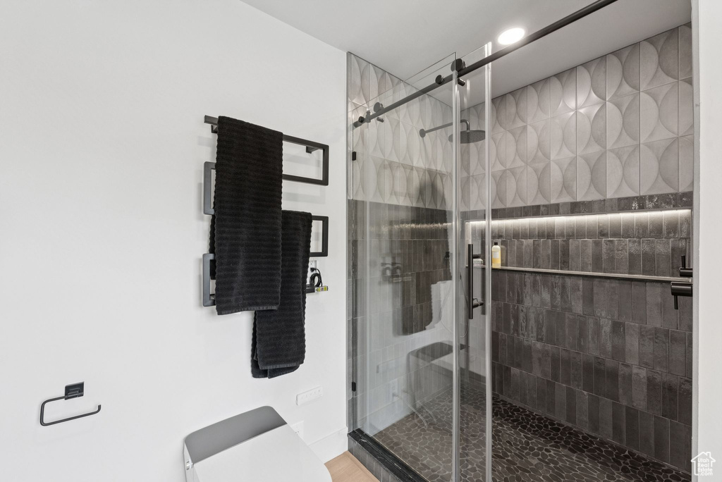 Bathroom with a shower stall and toilet