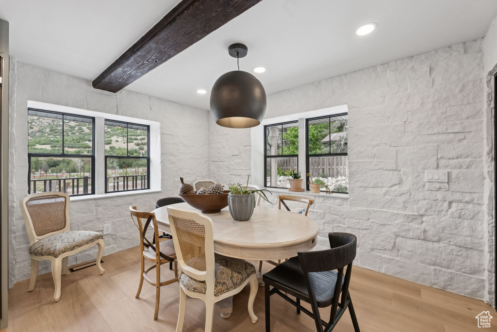Dining area featuring wood finished floors, recessed lighting, and beamed ceiling