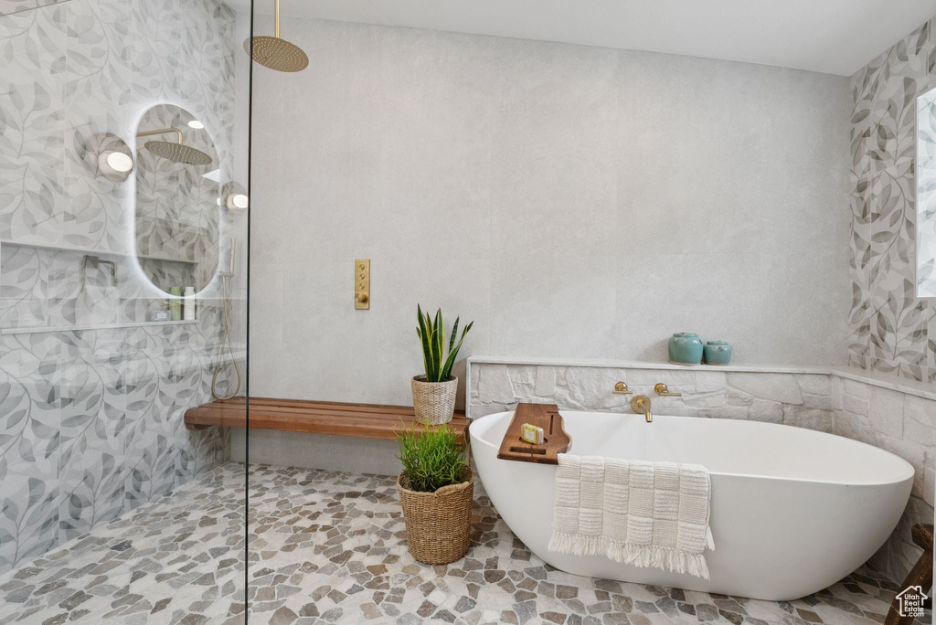 Full bath with walk in shower and a freestanding bath