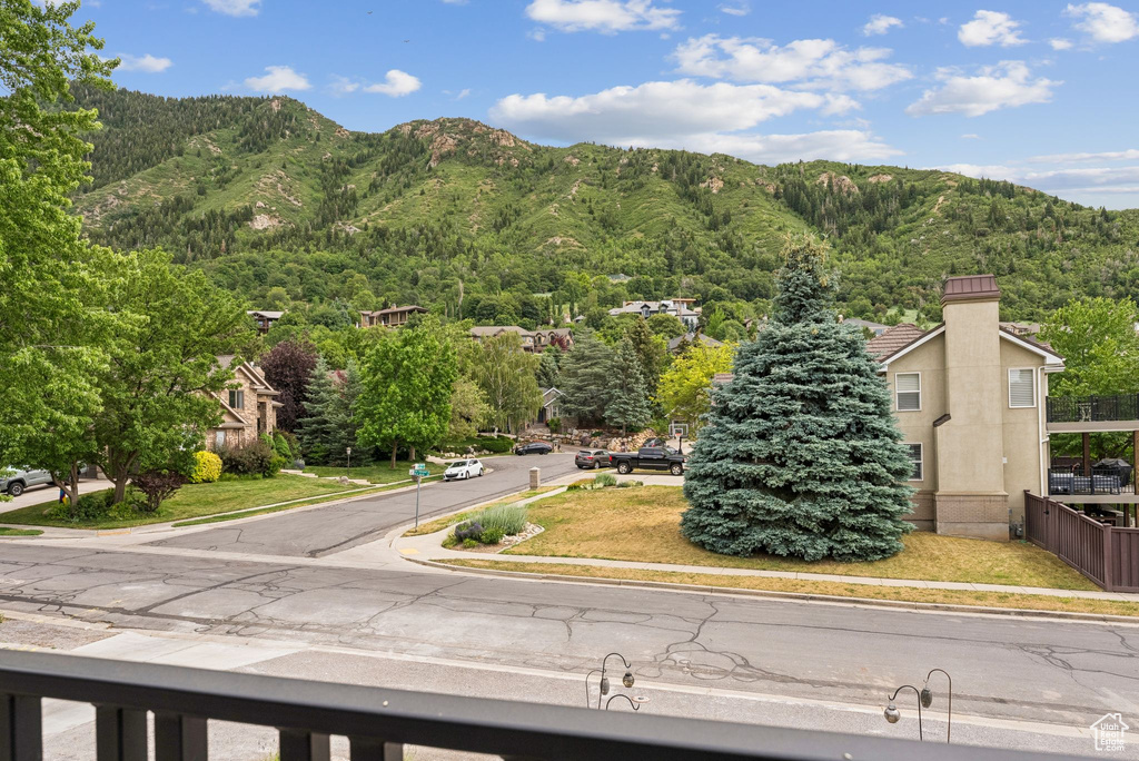 View of mountain backdrop featuring a heavily wooded area
