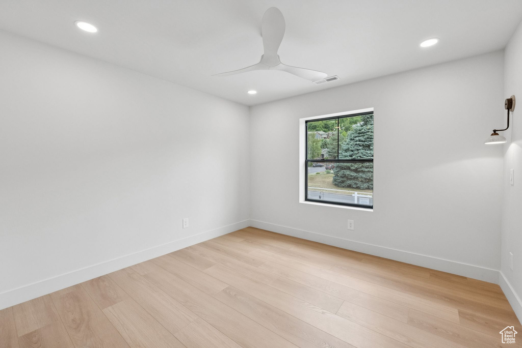 Spare room featuring a ceiling fan, light wood-style floors, and recessed lighting