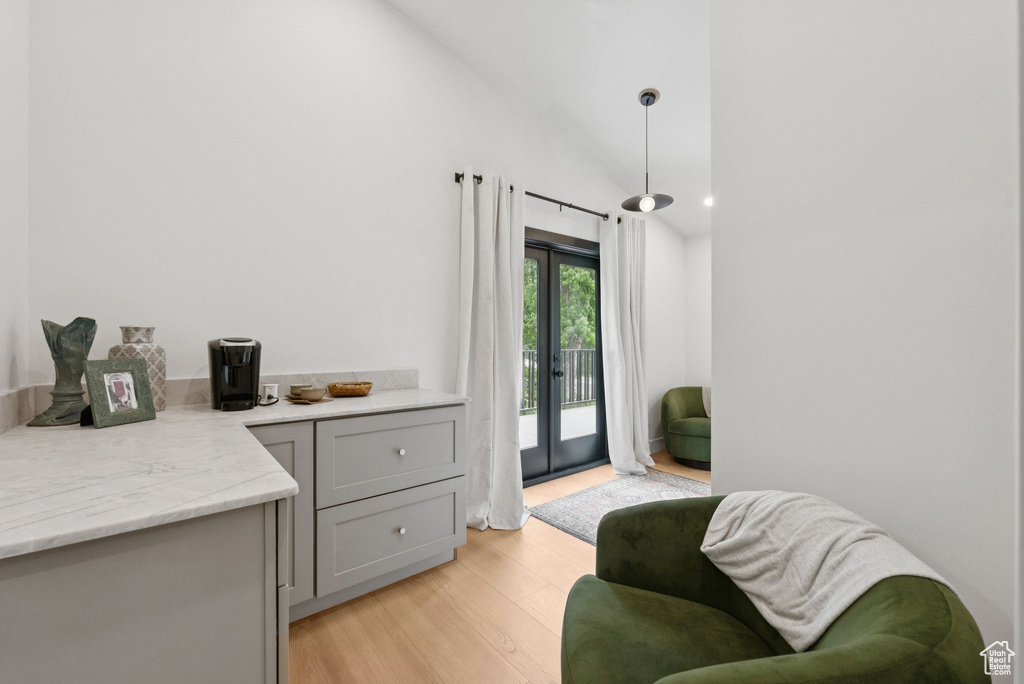 Sitting room featuring light wood-style flooring and lofted ceiling