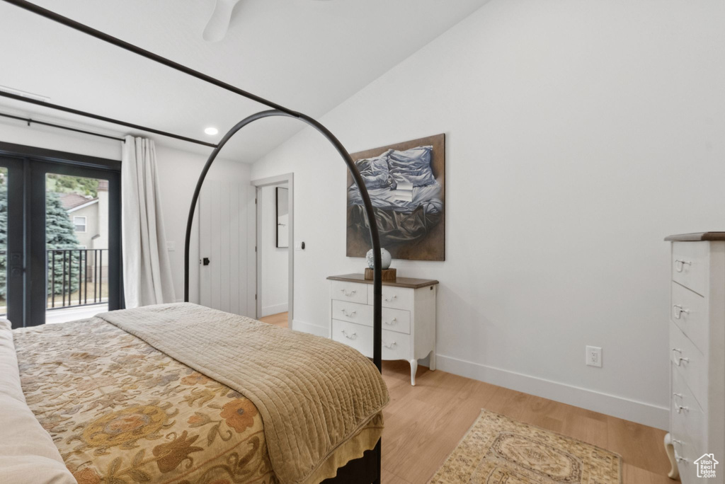 Bedroom with access to exterior, light wood-style flooring, lofted ceiling, and recessed lighting
