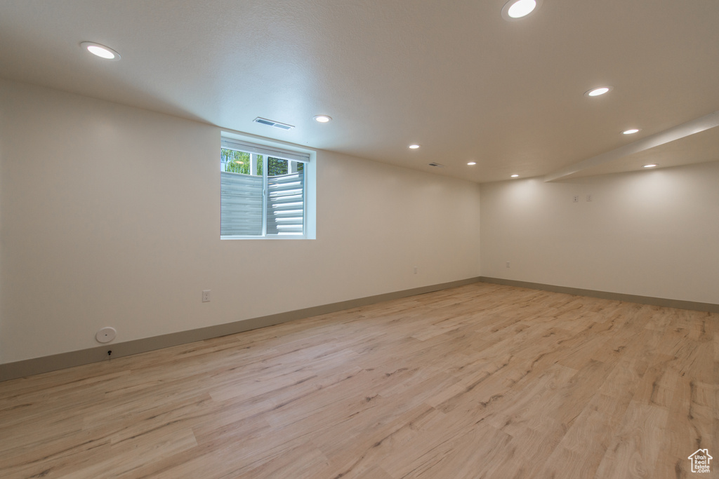 Unfurnished room featuring recessed lighting, light wood finished floors, and baseboards