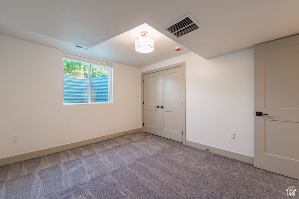 Unfurnished bedroom with carpet floors and baseboards